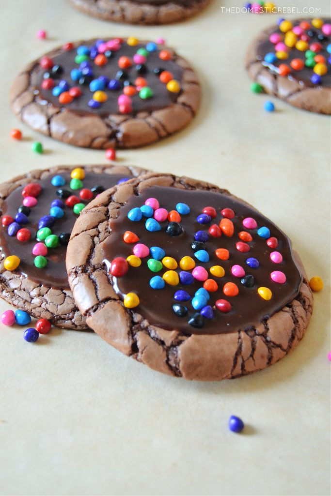 two cosmic brownie cookies resting on one another on parchment paper