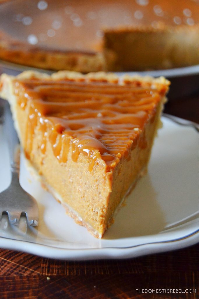 a closeup shot of a slice of salted caramel pumpkin pie on a white plate