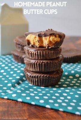 homemade peanut butter cups stacked up 4 high on a teal tea towel