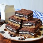 a large arrangement of slutty brownies on a black and white plate