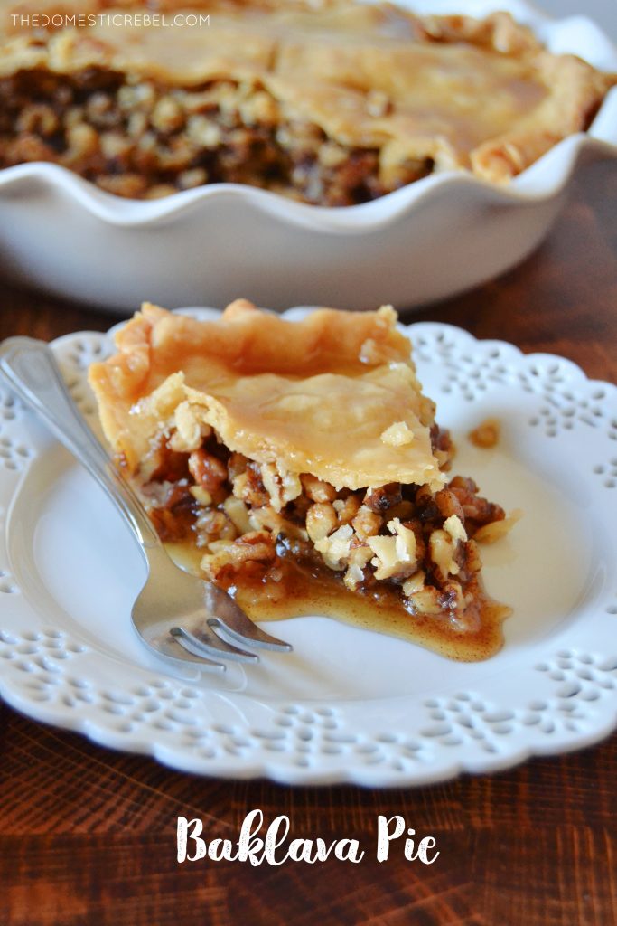 slice of baklava pie on a white lacy plate with a silver fork