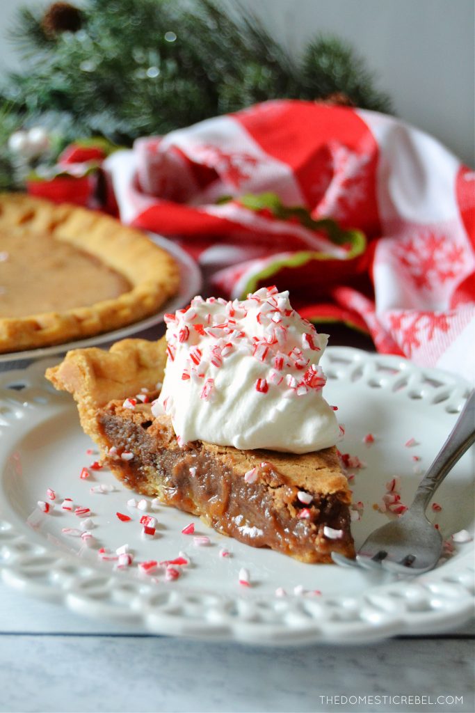 chocolate peppermint chess pie on a white plate with a red and white dishtowel in the background