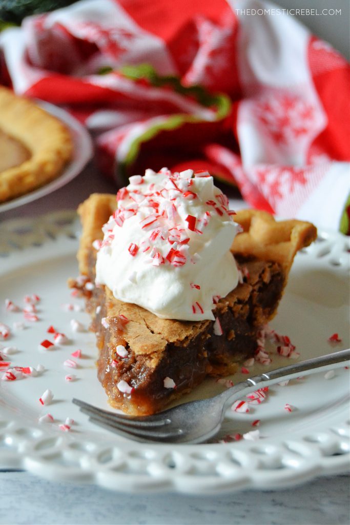 chocolate peppermint chess pie slice on a white lacy plate with a red and white checkered cloth in the background