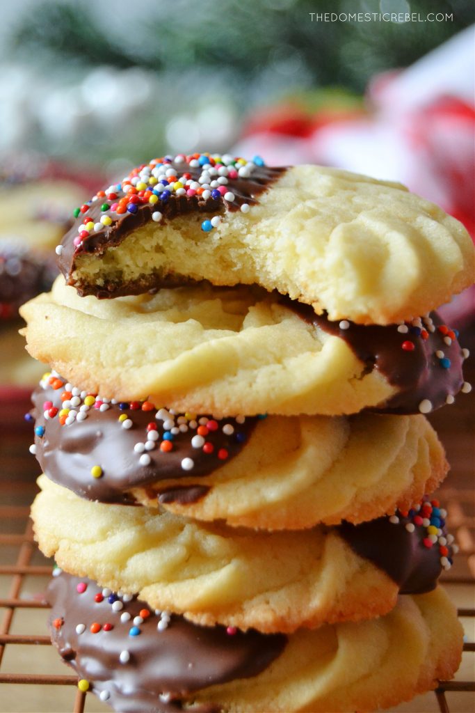stack of butter cookies and one has a bite missing