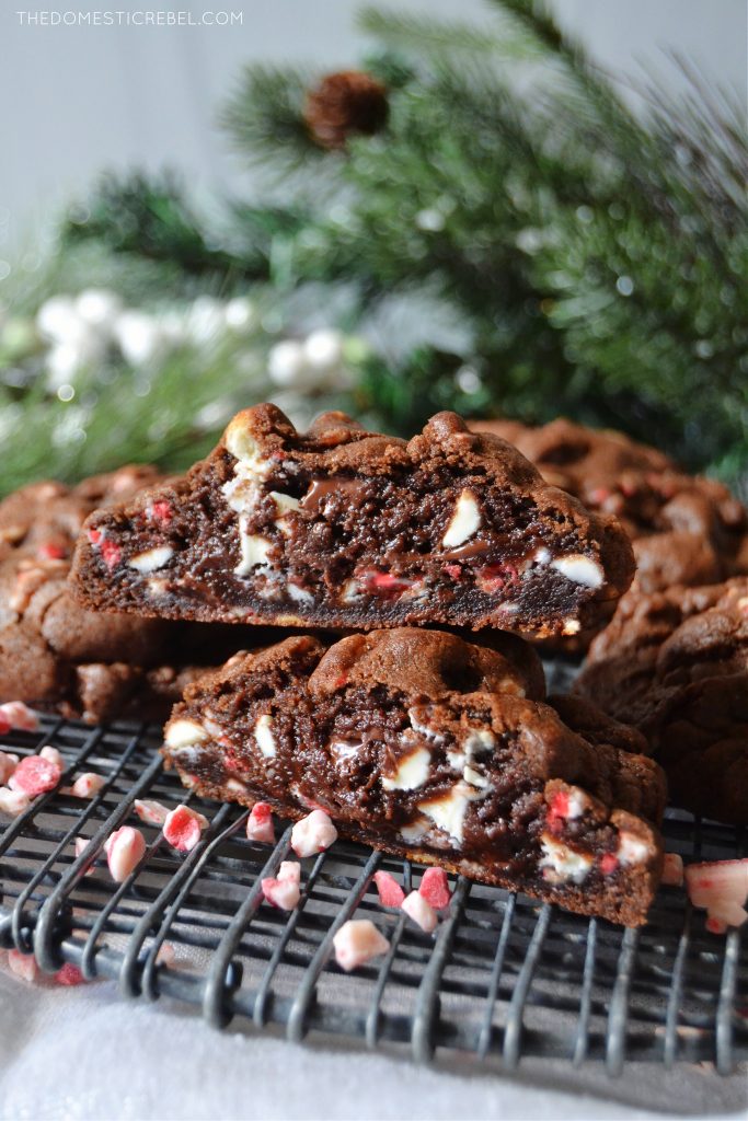 a double stack of chocolate peppermint cookies cut open to show texture on a black wire rack