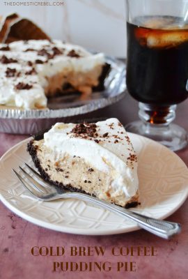slice of cold brew coffee pudding pie on a white textured plate with a fork and a cup of coffee in the background