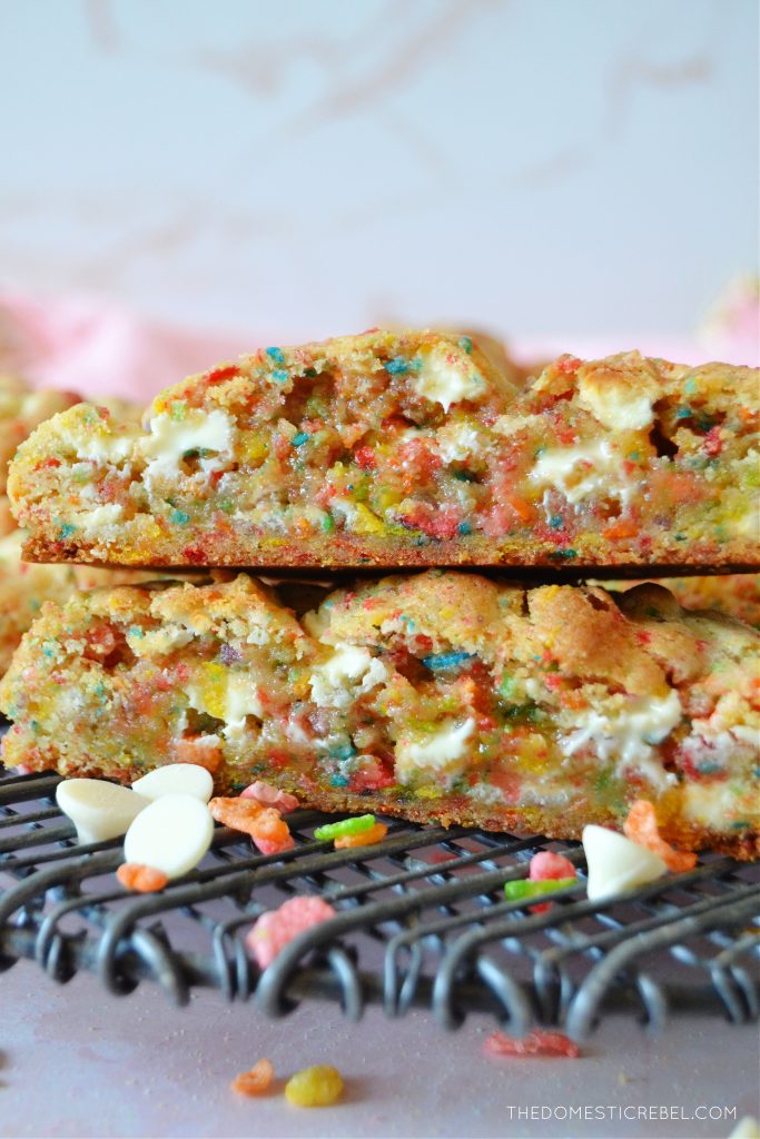 a stack of split open fruity pebble cookies on a black wire rack