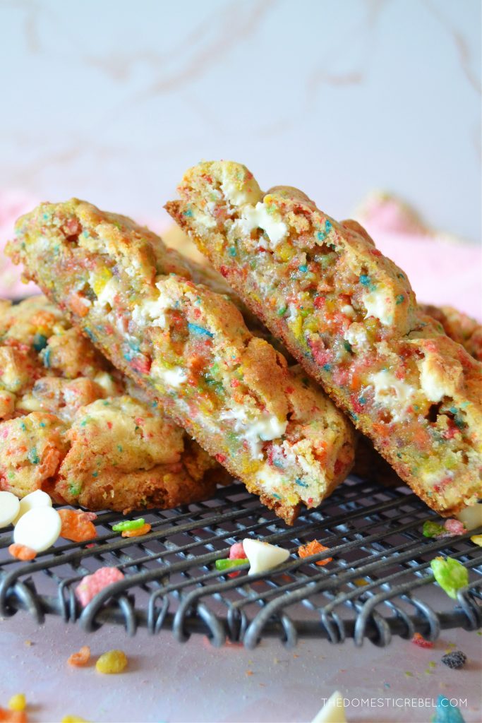 fruity pebble cookie halves stacked together on a wire rack