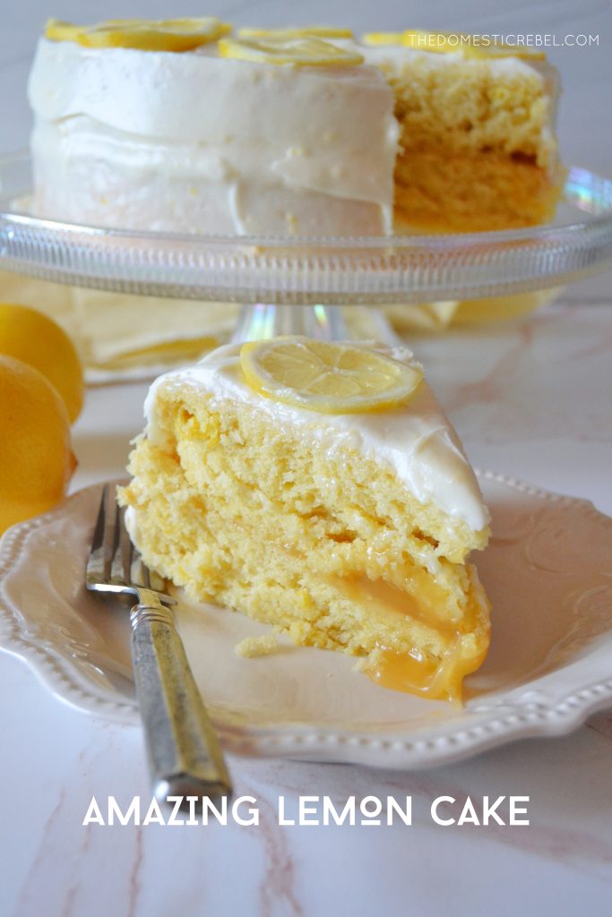 lemon layer cake slice on a white plate with the whole cake on a pedestal in the background
