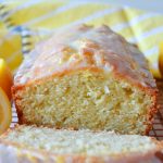 lemon loaf cake with a slice cut off the end of it