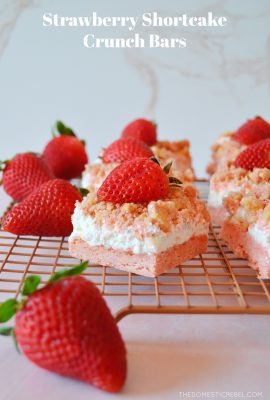 rows of strawberry shortcake bars on a wire rack with fresh strawberries on the side