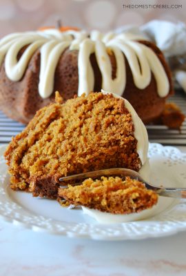 a piece of pumpkin bundt cake on its side with a fork taking a bite out of it