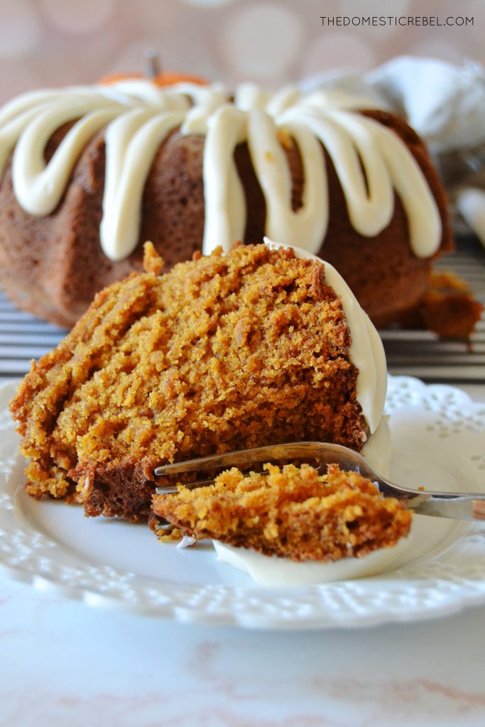 a piece of pumpkin bundt cake on its side with a fork taking a bite out of it