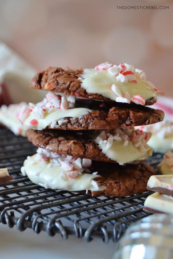 a quad stack of peppermint bark brownie cookies on a black wire rack