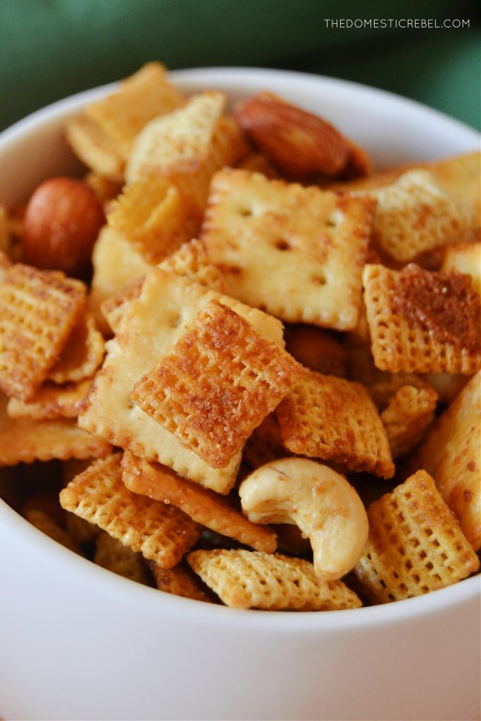 closeup of chex mix in a white bowl to show texture and ingredients