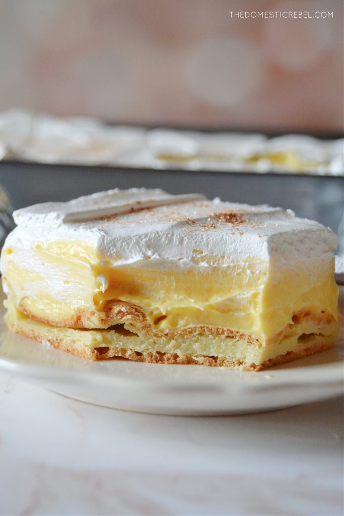 closeup shot of a slice of eggnog cream puff cake with a bite missing to show interior texture