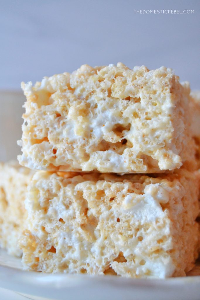 a closeup of a double stack of brown butter vanilla rice krispy treats against a light grey background