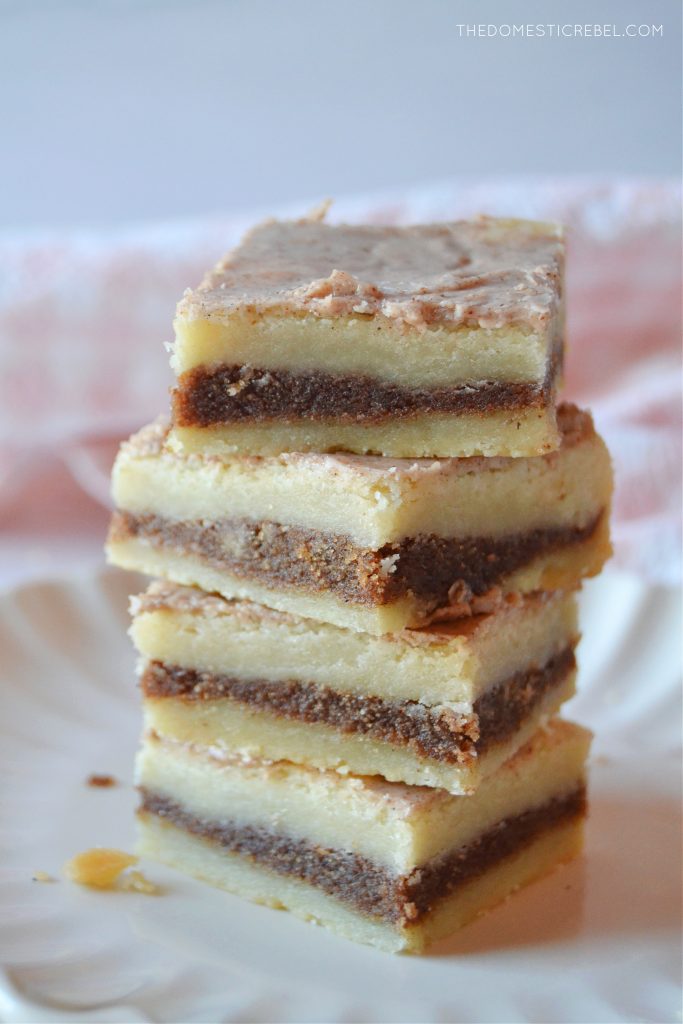 a four-high stack of pop tart bars on a white scalloped plate.