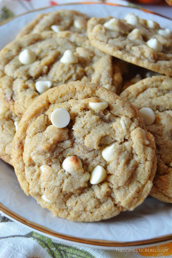 a closeup photo of a plate full of white chocolate pumpkin spice cookies. 